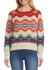 Woman wearing a colorful patterned sweater with blue jeans on a white background