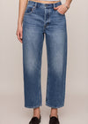 Person wearing blue jeans on a plain background