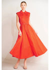 Woman wearing a red dress against a plain background