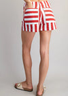 Red and white striped shorts worn by a person on a plain background