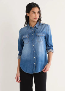  Woman wearing a blue denim shirt on a white background
