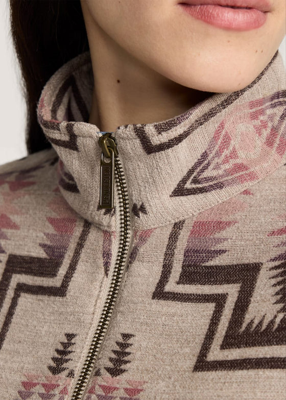 Close-up of a person wearing a patterned jacket with a zipper.