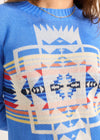 Close-up of a blue sweater with geometric pattern