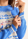Close-up of a blue sweater with geometric pattern
