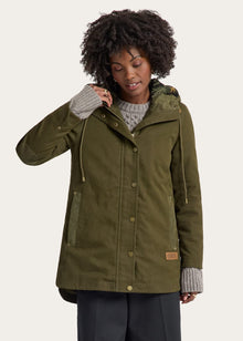  Woman wearing a green parka jacket on a white background