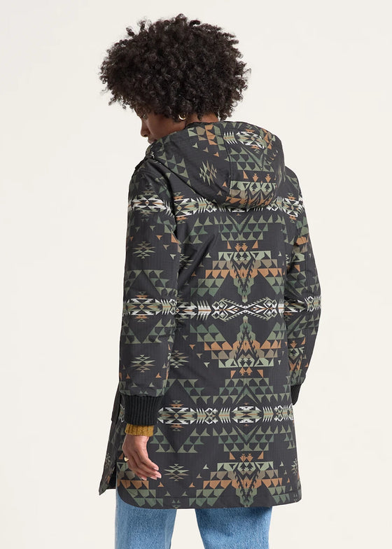Person wearing a patterned coat on a white background