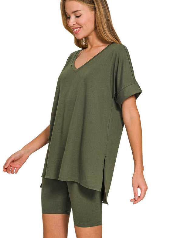 Woman wearing a green oversized t-shirt and shorts set on a white background
