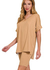 Woman wearing a beige outfit with a plain background