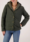 Person wearing a green quilted jacket with a hood on a plain background