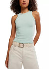 Woman wearing a light blue sleeveless top and beige pants on a white background