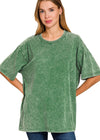 Woman wearing a dark green oversized t-shirt on a white background