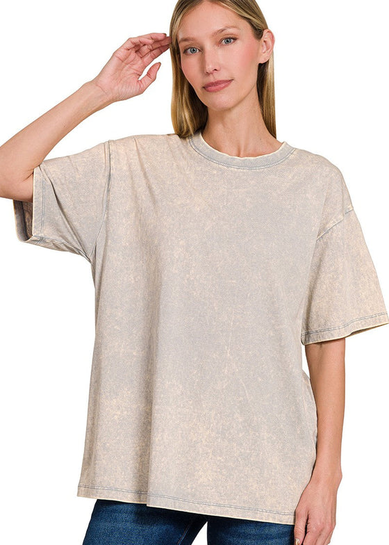 Woman wearing a light gray oversized t-shirt on a white background