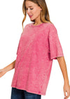 Woman wearing an ash pink t-shirt on a white background
