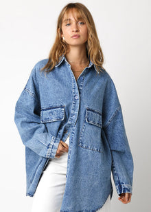  Person wearing a blue denim shirt on a white background