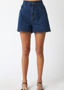  Denim shorts worn by a person on a white background