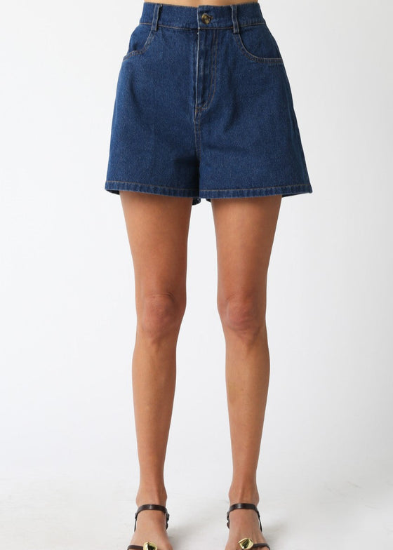 Denim shorts worn by a person on a white background