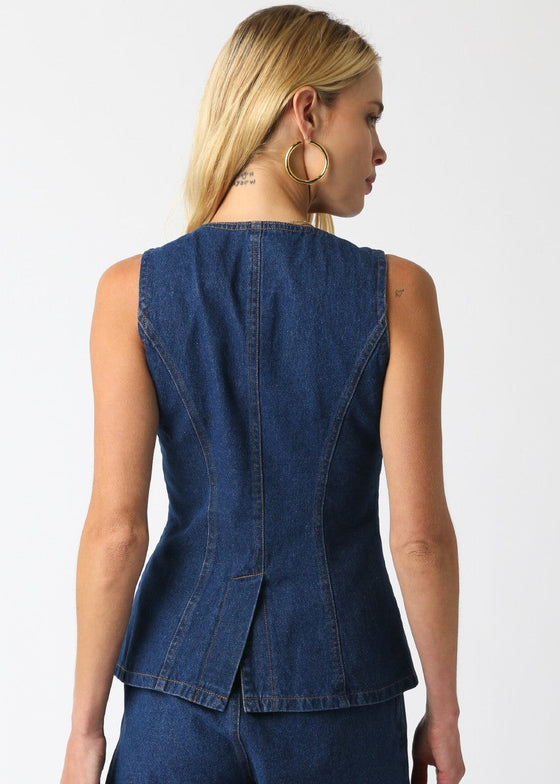 Woman wearing a blue denim vest on a white background
