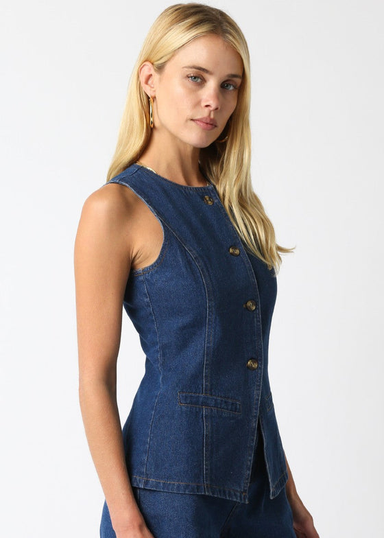 Woman wearing a blue denim sleeveless top on a white background