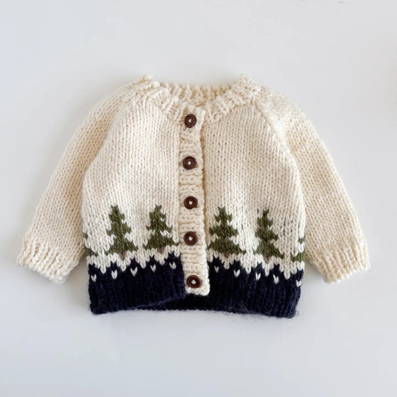 Knitted sweater with tree pattern on a light gray background