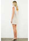 Woman wearing a white sleeveless dress on a plain background