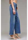 Person wearing blue jeans on a plain background