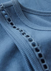Close-up of a blue fabric with decorative stitching detail