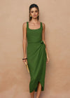 Woman wearing a green dress against a beige background
