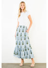 Woman wearing a white top and blue floral skirt on a white background