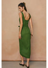 Woman wearing a green dress with a beige background