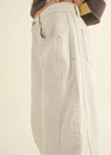 Beige pants worn by a person on a plain background