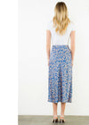 Woman wearing a blue floral skirt on a white background