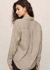 Person wearing a plaid shirt against a plain background