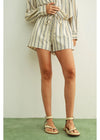 Person wearing a striped outfit with shorts and a top on a plain background