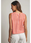 Woman wearing a sleeveless orange and white striped top against a plain background