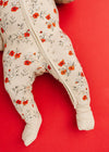 Baby onesie with floral pattern on a red background
