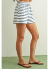 Person wearing blue and white striped shorts on a plain background