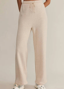  Beige pants worn by a person on a plain background
