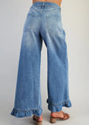Blue denim wide-leg pants with ruffled cuffs on a plain background