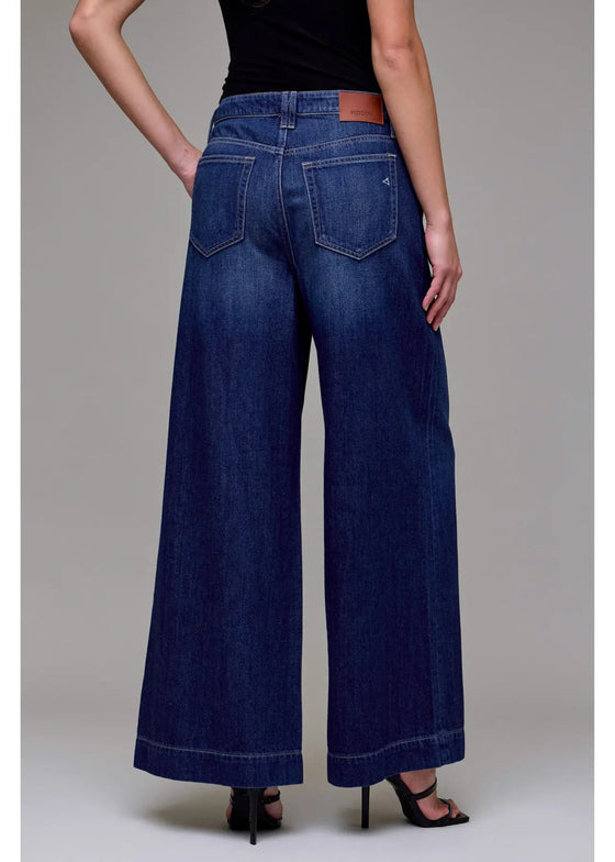 Wide-leg jeans worn by a person on a plain background