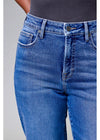 Blue jeans worn by a person on a gray background