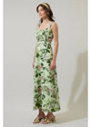 Woman wearing a floral dress against a plain background