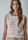 Woman wearing a sleeveless knitted top with red stripes against a plain background