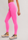 Person wearing bright pink leggings and a matching top on a light gray background