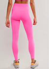 Person wearing bright pink leggings on a light gray background