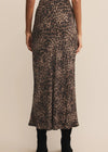 Person wearing a leopard print skirt on a beige background