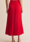 Red skirt worn by a person on a beige background