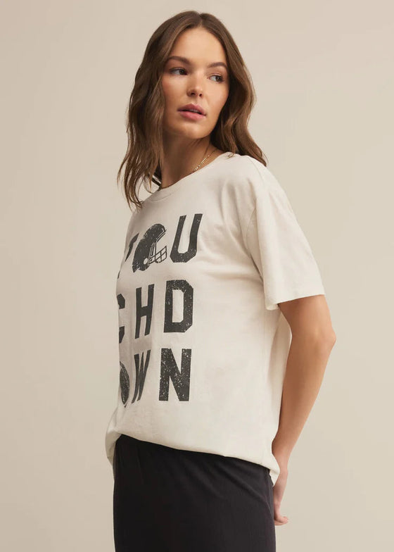 Woman wearing a white t-shirt with text on a beige background
