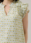Woman wearing a floral dress with yellow flowers on a white background