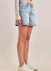 Denim skirt worn by a person on a beige background
