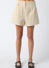 Beige shorts worn by a person on a white background